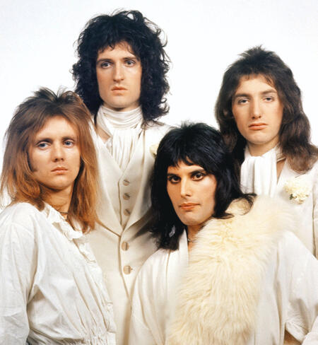 70's Queen all dressed in white, posing seriously.
